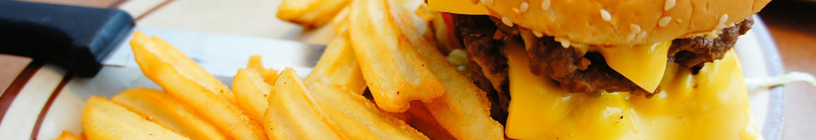 Eating American (Traditional) Burger Cheesesteak at Famous Philly Cheese Steak & Wings restaurant in Denver, CO.